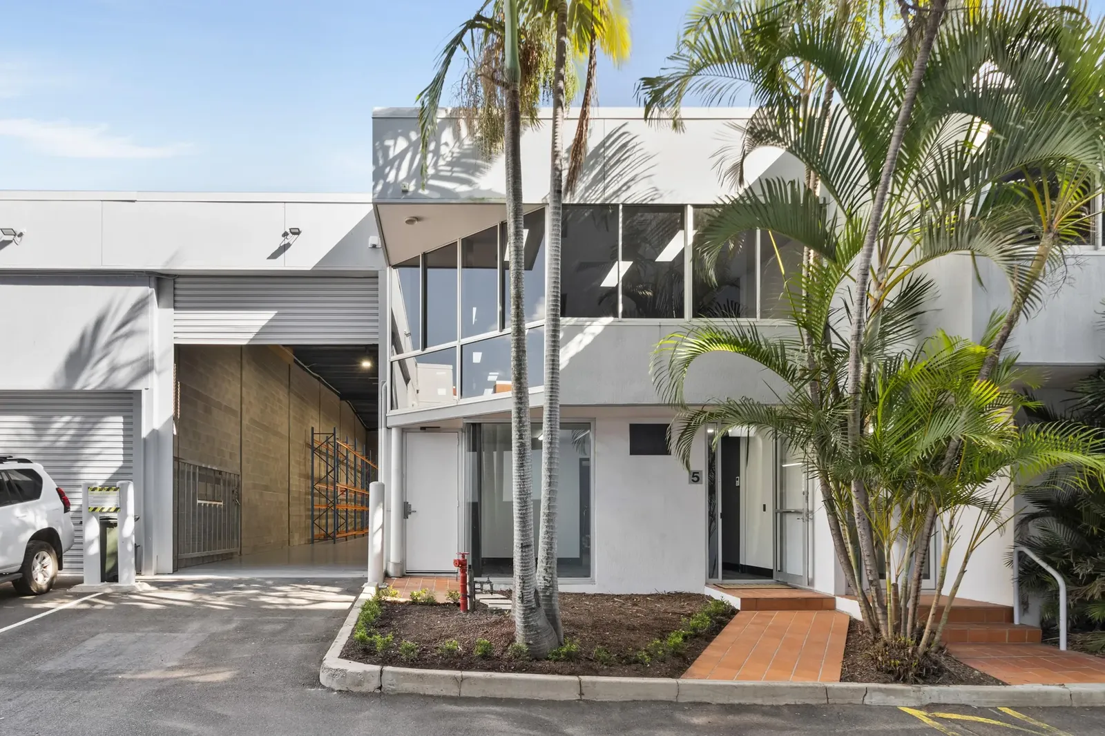 Commercial property frontage with glass facade and warehouse
